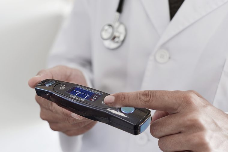 A doctor holding a Cardio Assistant PRO cardiac recorder